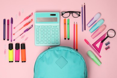 Flat lay composition with backpack and different stationery on pink background. Back to school