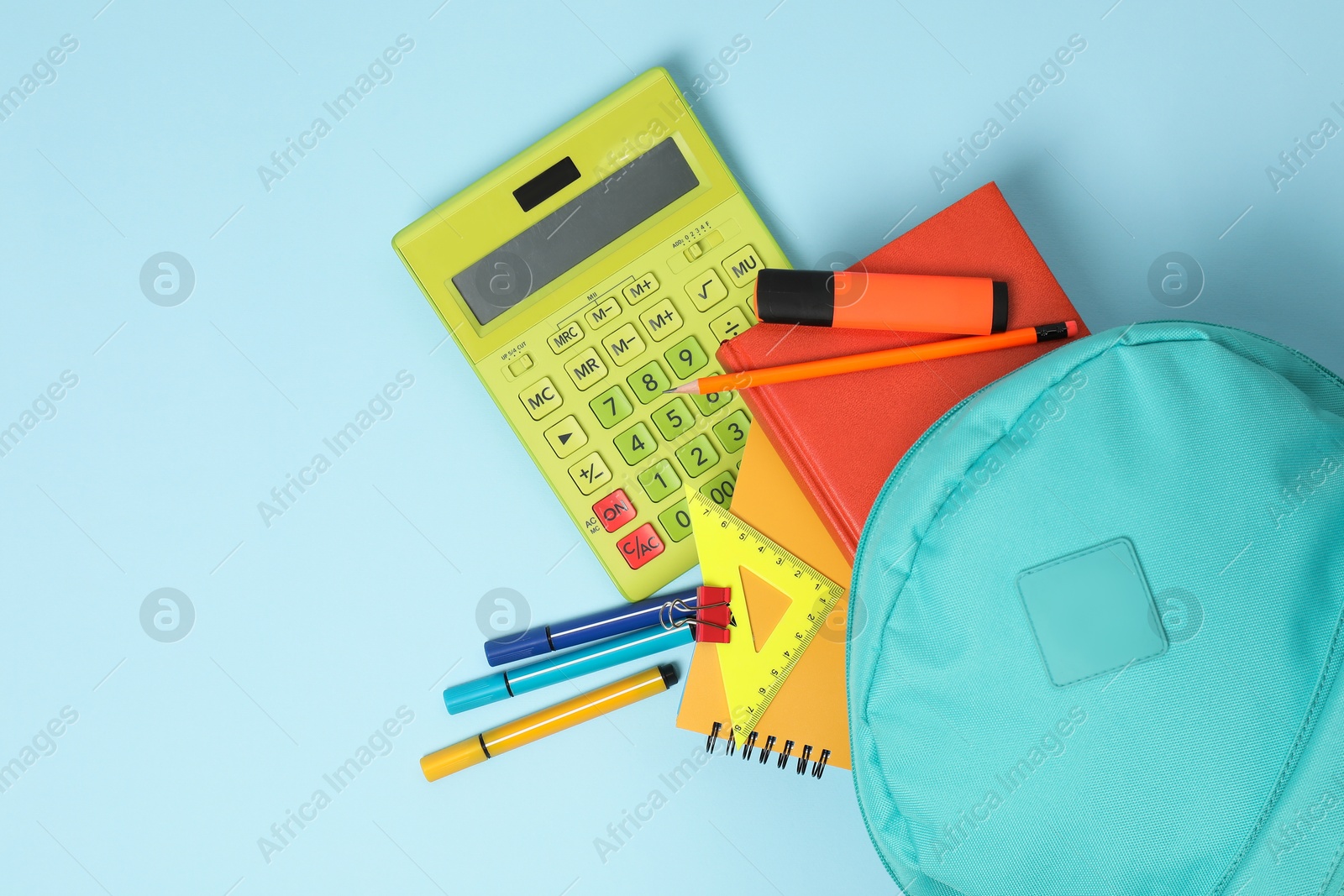 Photo of Backpack with different school stationery on light blue background, flat lay