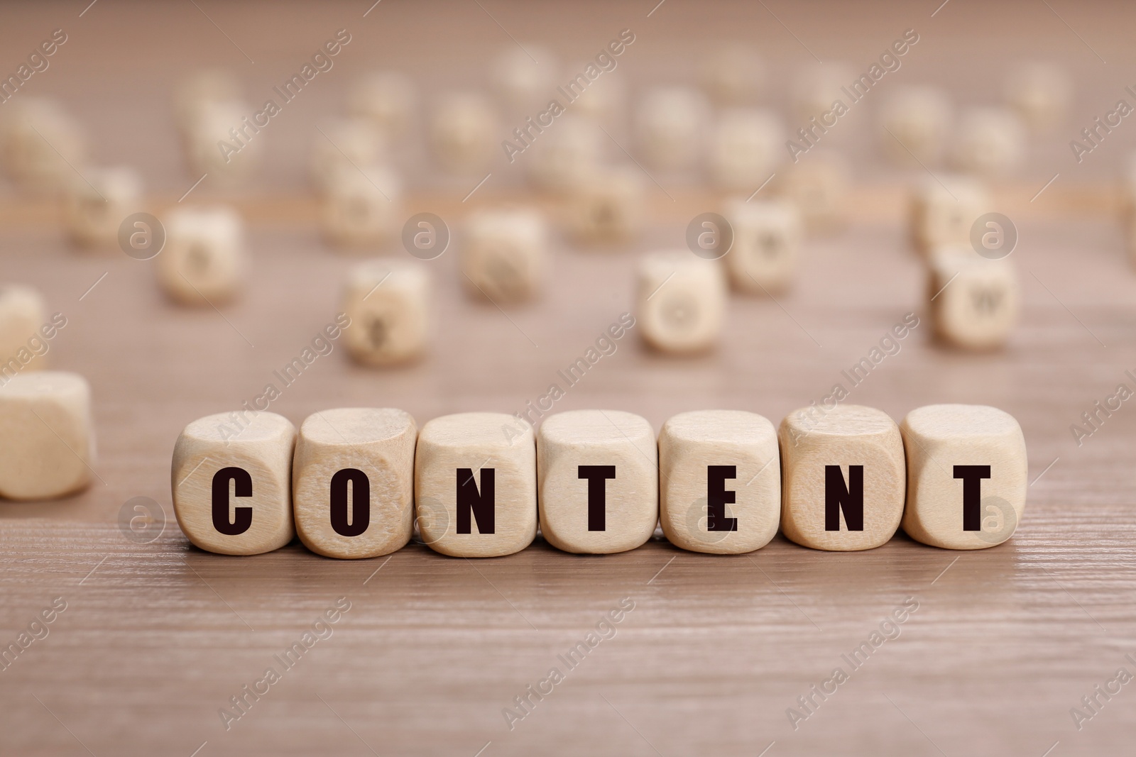 Image of Word Content made of cubes with letters on wooden table, closeup