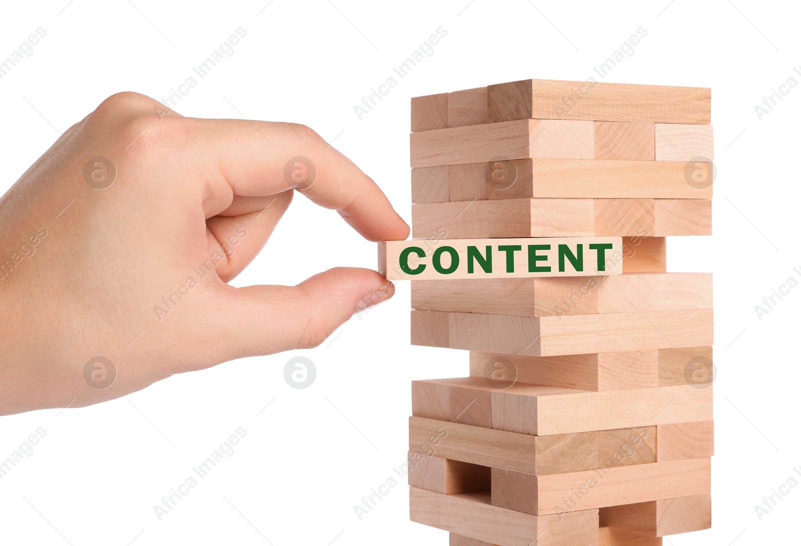 Image of Man removing wooden block with Content from tower on white background, closeup