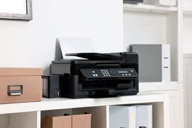 Photo of Modern printer with paper on table in office