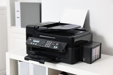 Photo of Modern printer with paper on table in office