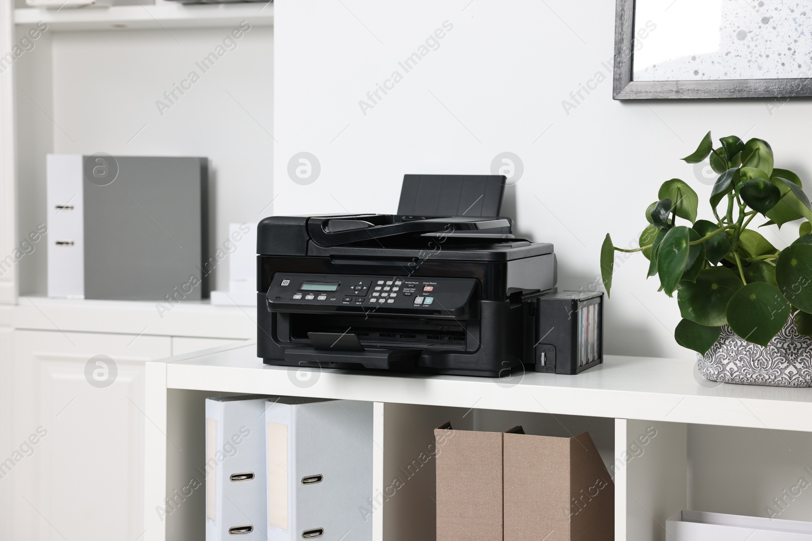 Photo of Modern printer on white table in office