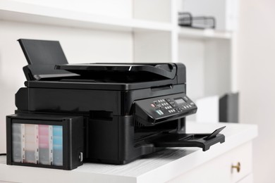 Photo of Modern printer on white table in office