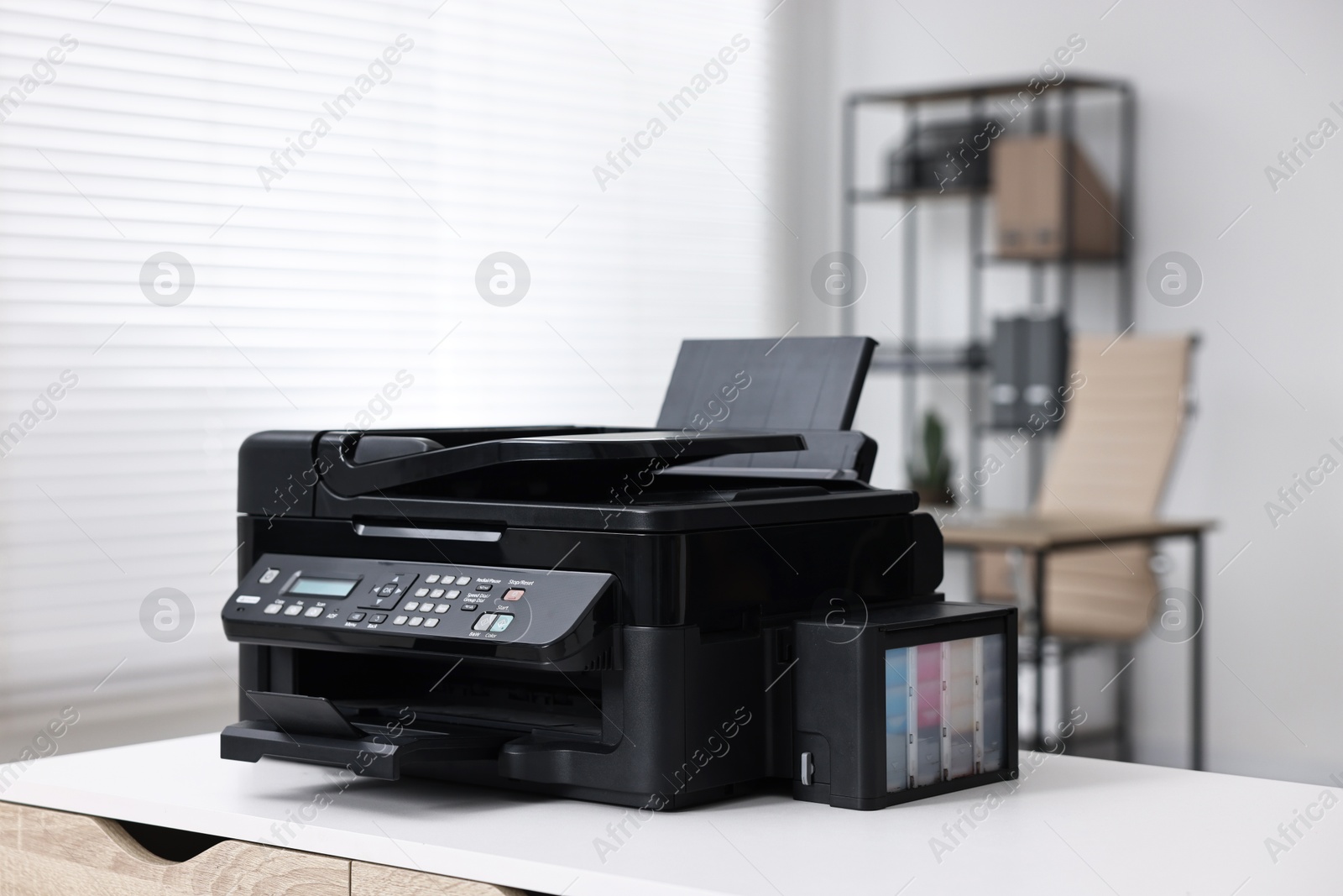 Photo of Modern printer on white table in office