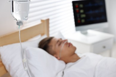 Photo of Coma patient. Young man sleeping in hospital bed, selective focus