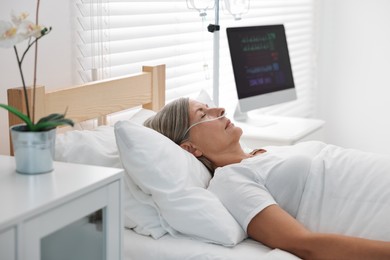 Coma patient. Mature woman sleeping in hospital bed