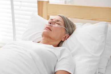 Photo of Coma patient. Mature woman sleeping in hospital bed