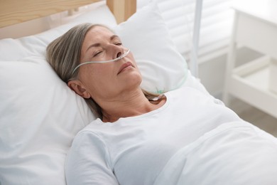 Coma patient. Mature woman sleeping in hospital bed