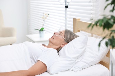 Photo of Coma patient. Mature woman sleeping in hospital bed