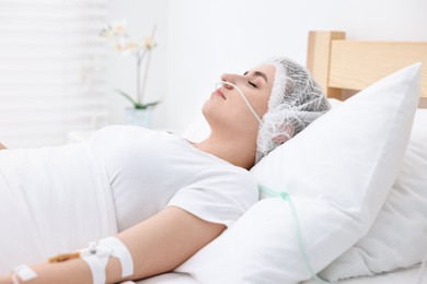 Photo of Coma patient. Woman with intravenous drip in hospital bed