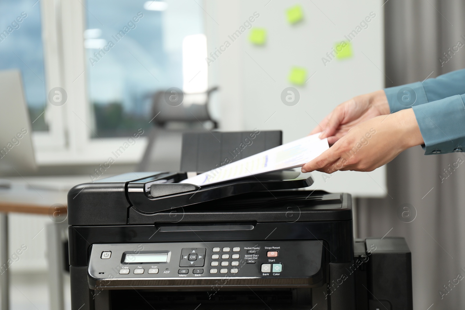 Photo of Woman using modern printer at workplace indoors, closeup