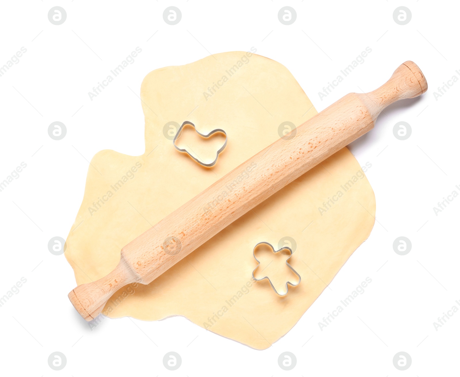 Photo of Raw dough, wooden rolling pin and cookie cutters isolated on white, top view