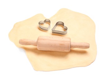 Raw dough, wooden rolling pin and cookie cutters isolated on white