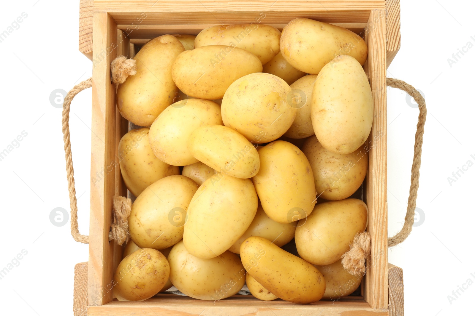 Photo of Young potatoes in wooden crate isolated on white, top view