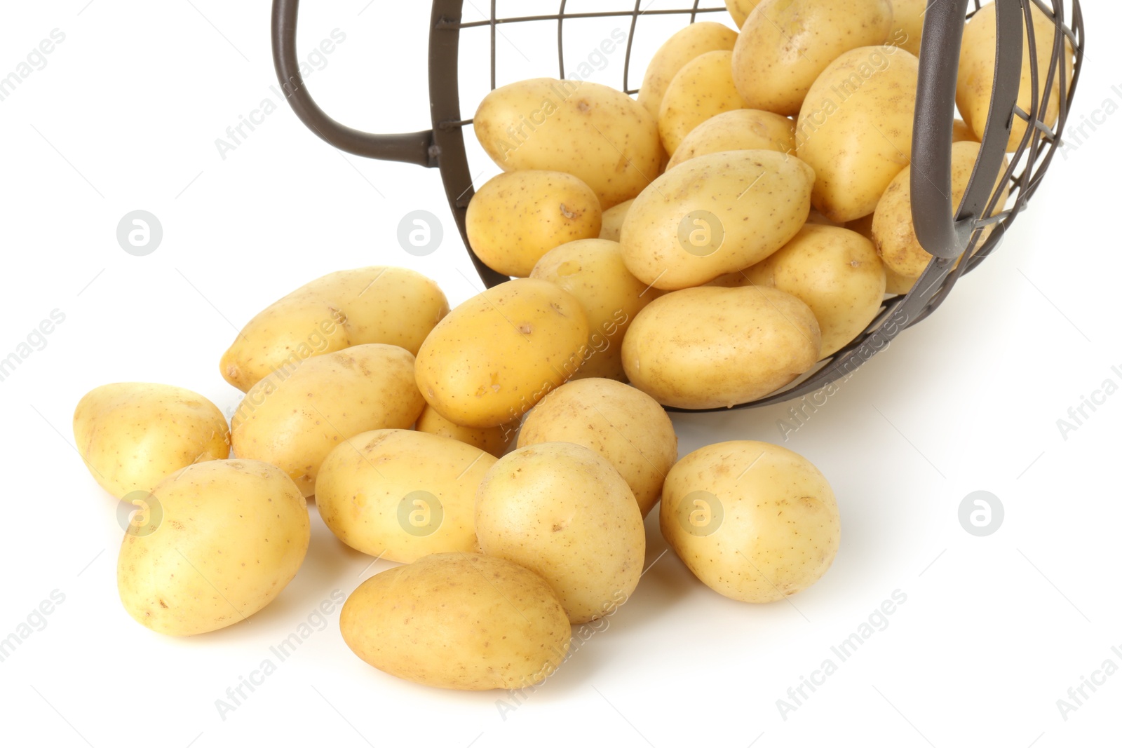 Photo of Young potatoes with metal basket isolated on white