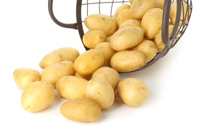 Photo of Young potatoes with metal basket isolated on white