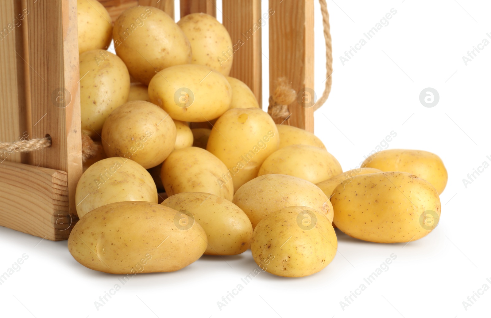 Photo of Young potatoes in wooden crate isolated on white