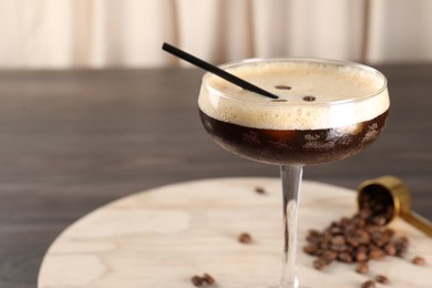 Fresh coffee cocktail in glass and beans on table, closeup. Space for text