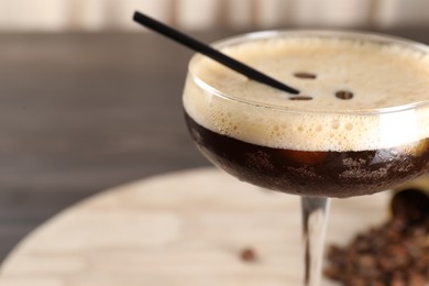 Photo of Fresh coffee cocktail in glass on table, closeup. Space for text