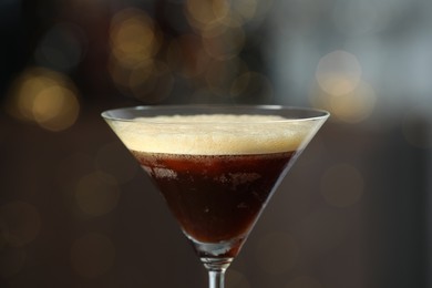 Refreshing cocktail in glass on blurred background, closeup