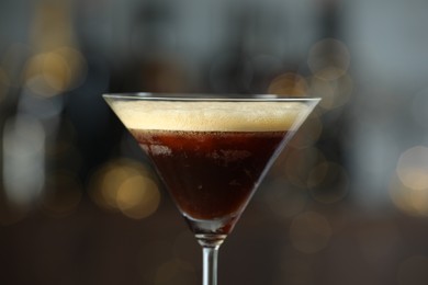 Refreshing cocktail in glass on blurred background, closeup