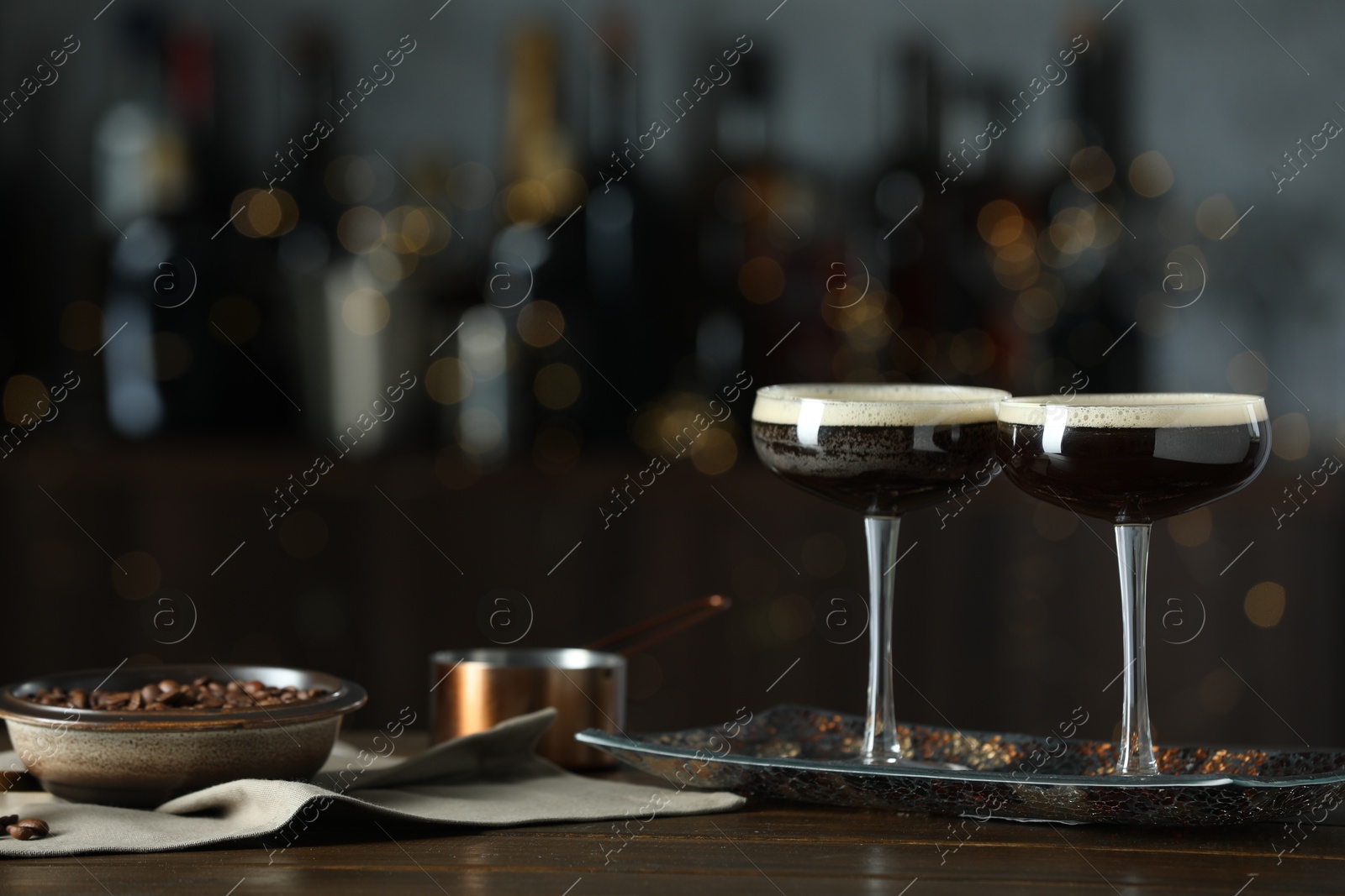 Photo of Refreshing cocktails and coffee beans on wooden table