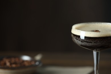 Refreshing cocktail in glass on blurred background, closeup. Space for text