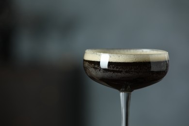 Refreshing cocktail in glass on blurred background, closeup