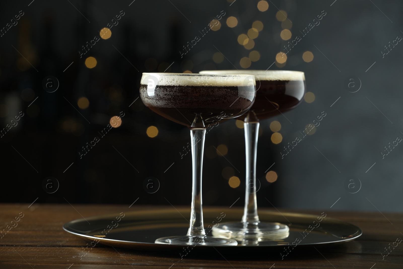 Photo of Refreshing cocktails in glasses on wooden table