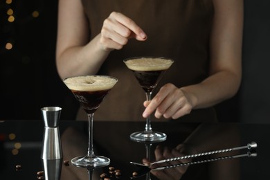 Photo of Bartender making cocktails at counter in bar, closeup