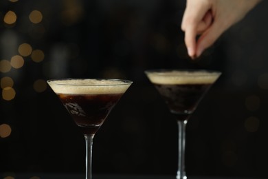 Bartender making cocktails on blurred background, closeup