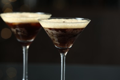 Refreshing cocktail in glasses on blurred background, closeup