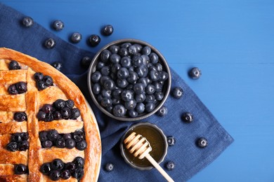 Photo of Tasty homemade pie with blueberries served on blue table, flat lay