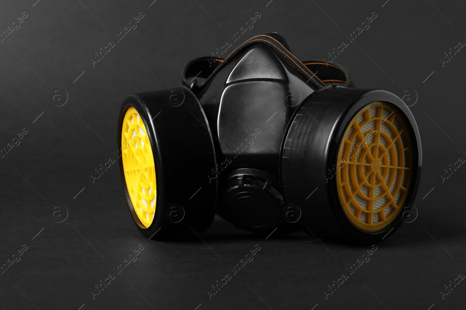 Photo of One respirator mask on black background, closeup