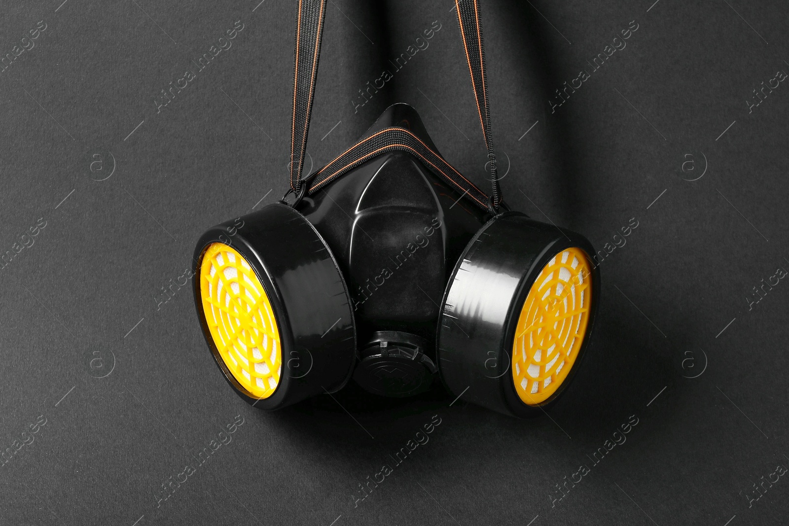 Photo of One respirator mask on black background, above view