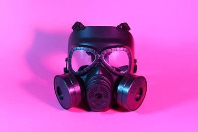 Photo of One gas mask on pink background. Safety equipment