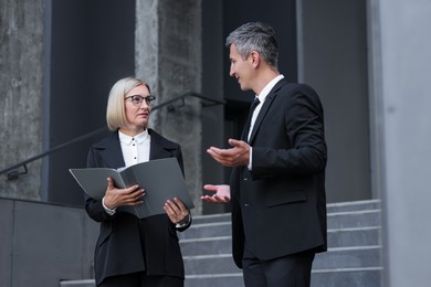 Photo of International relations. Diplomats talking during meeting outdoors