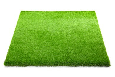 Photo of Green artificial grass isolated on white. Garden decor