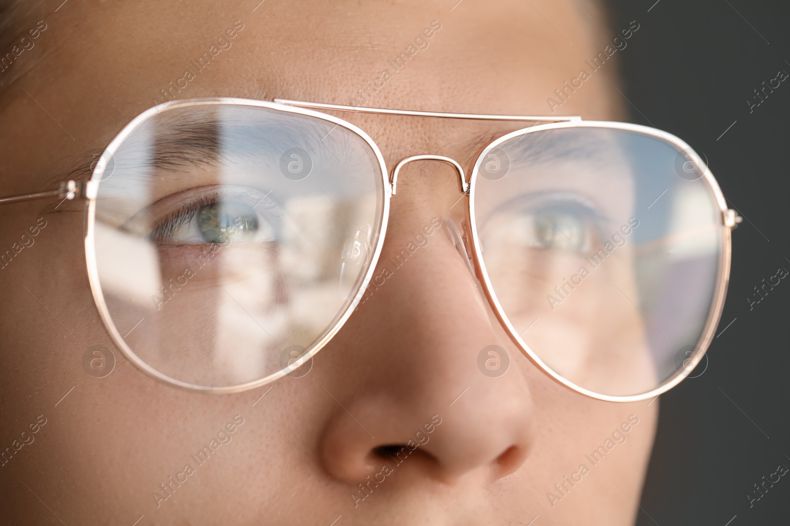 Photo of Vision correction. Man wearing glasses on grey background, closeup