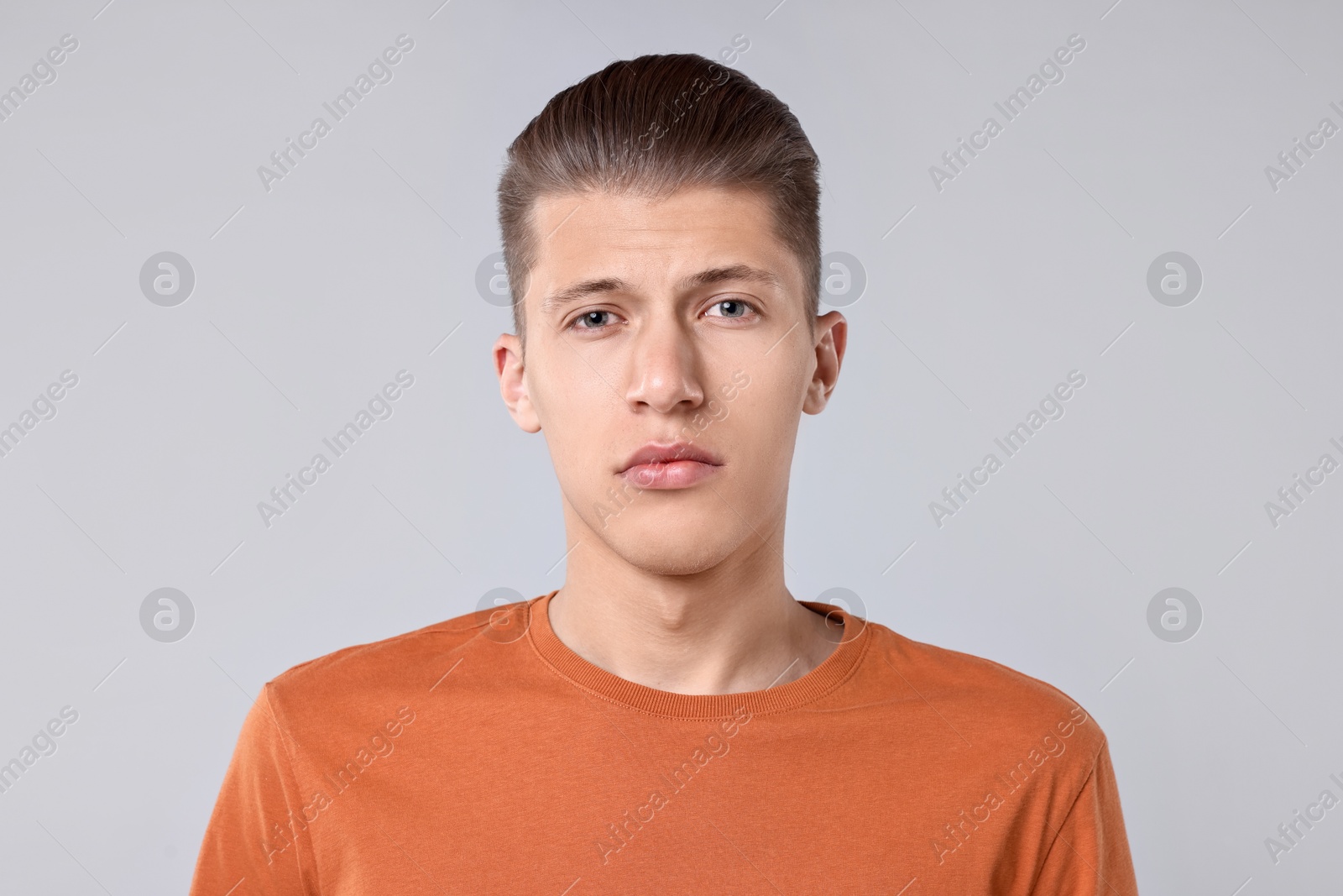 Photo of Portrait of handsome young man on light grey background