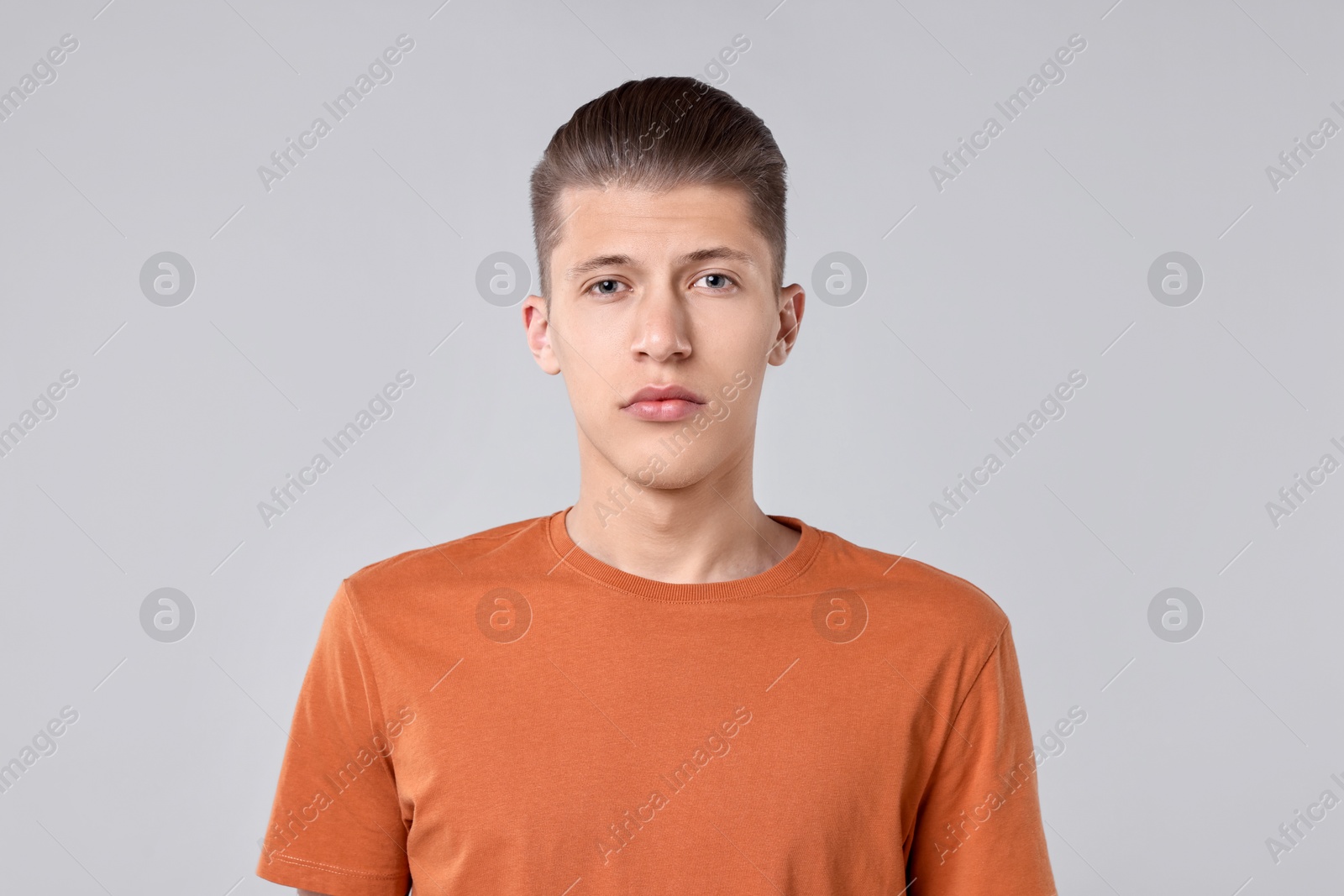 Photo of Portrait of handsome young man on light grey background