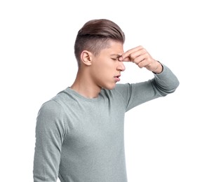 Young man suffering from sinusitis on white background