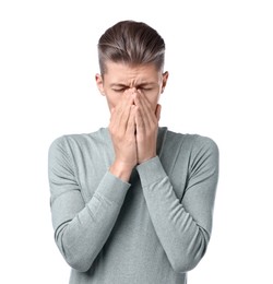 Young man suffering from sinusitis on white background