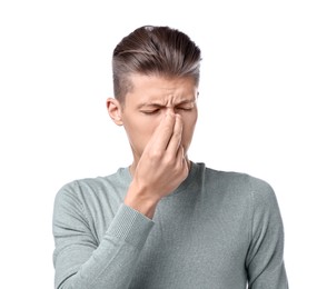 Young man suffering from sinusitis on white background