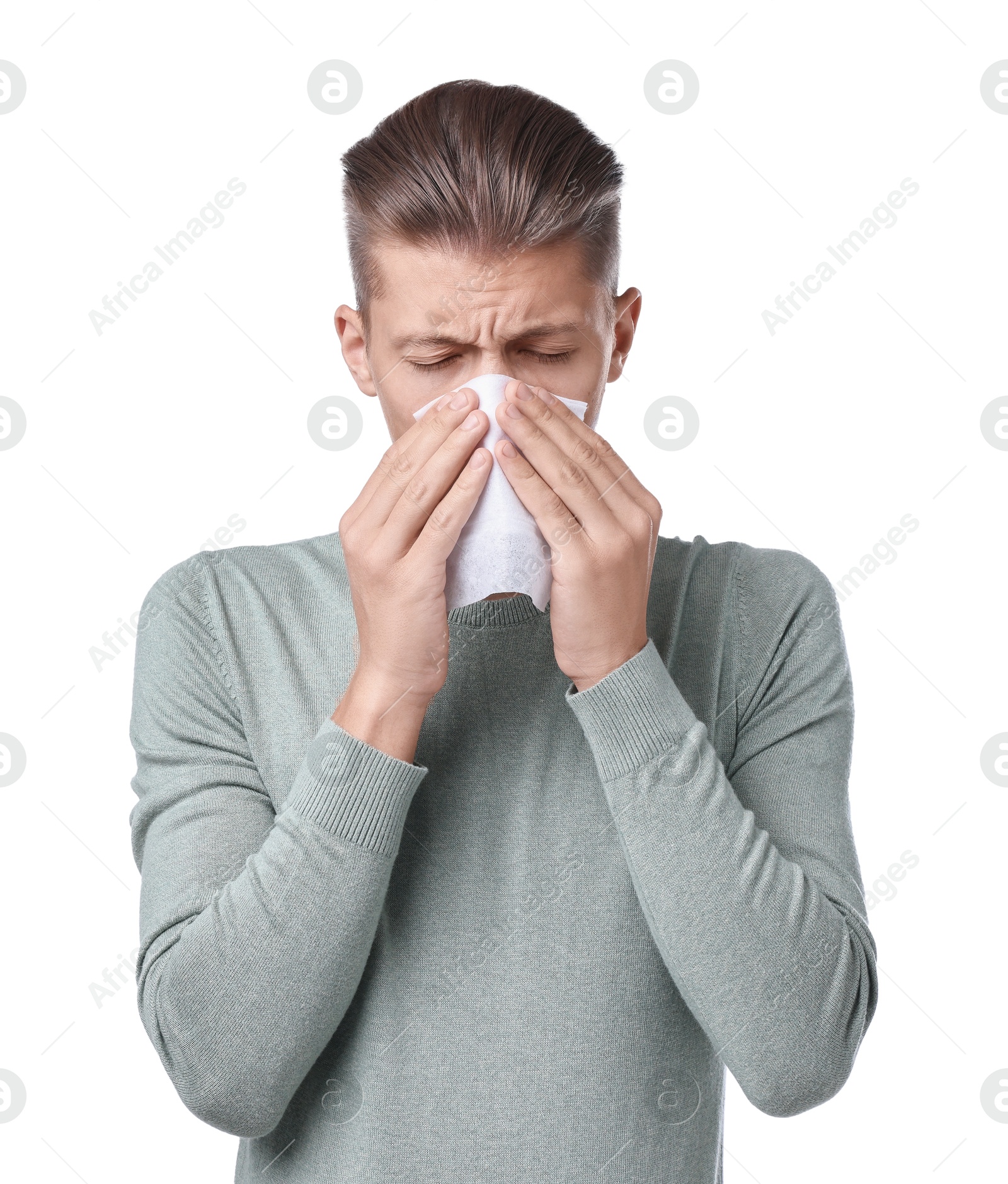 Photo of Young man with tissue suffering from sinusitis on white background