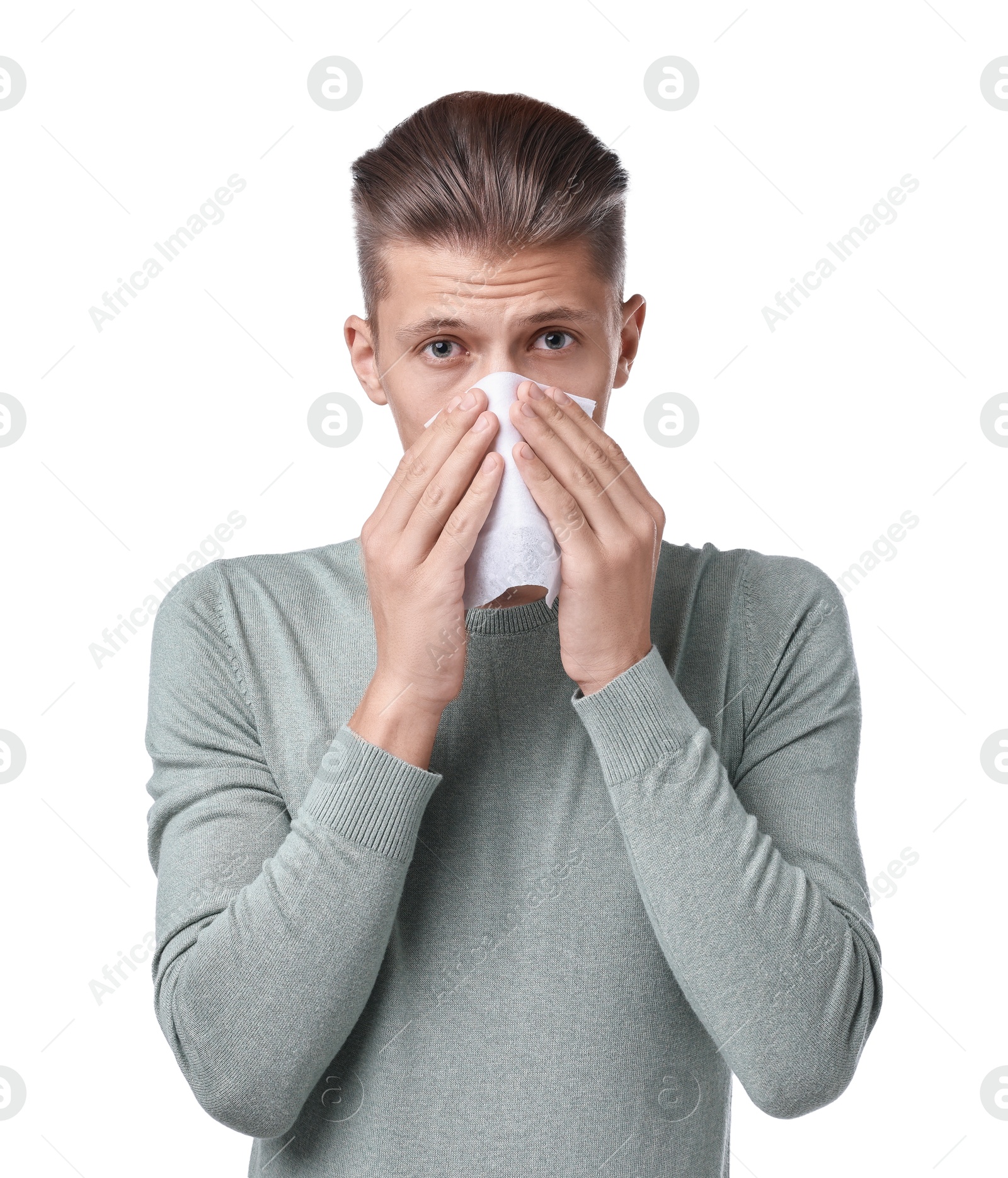 Photo of Young man with tissue suffering from sinusitis on white background