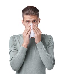 Photo of Young man with tissue suffering from sinusitis on white background