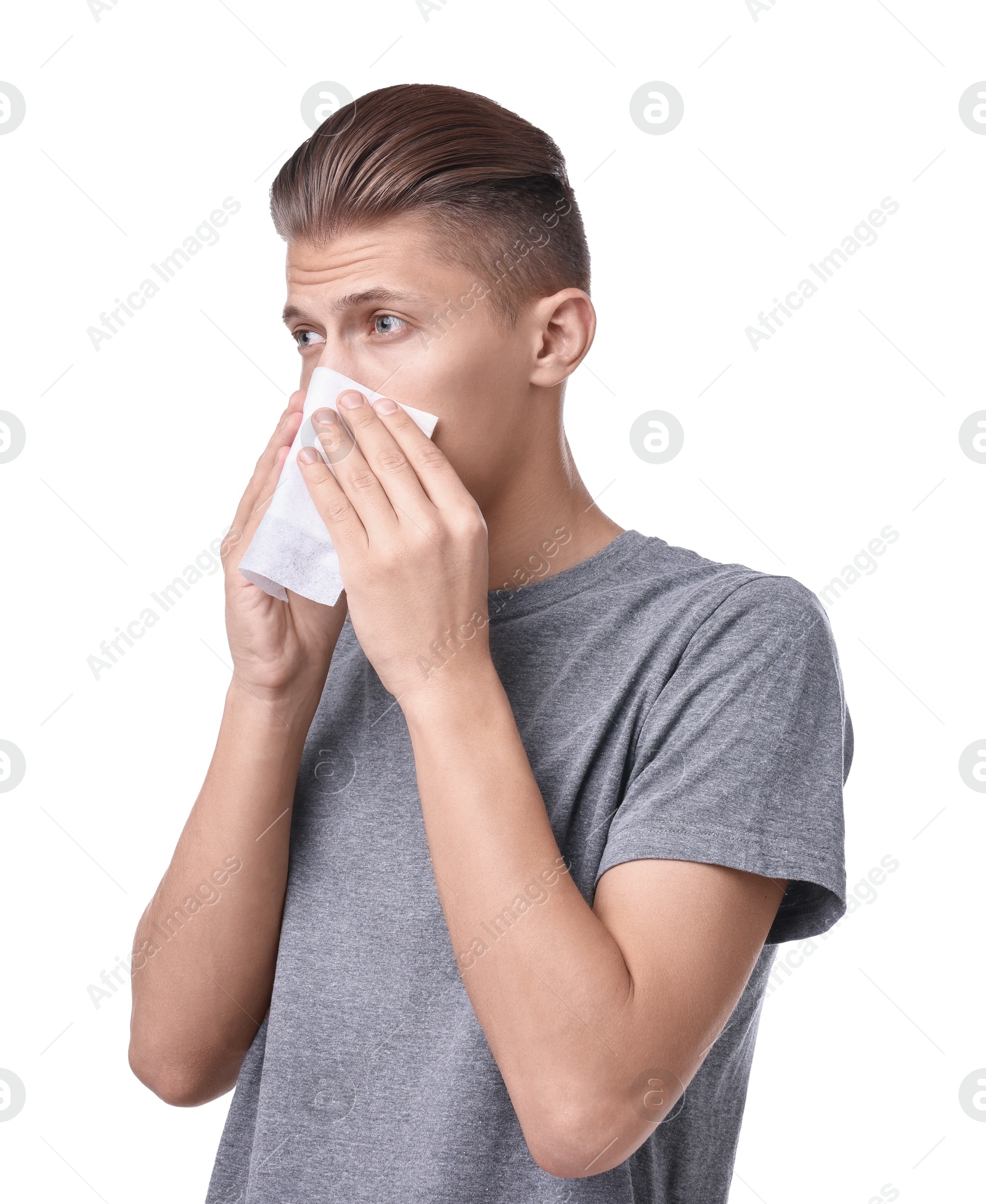 Photo of Young man with tissue suffering from sinusitis on white background