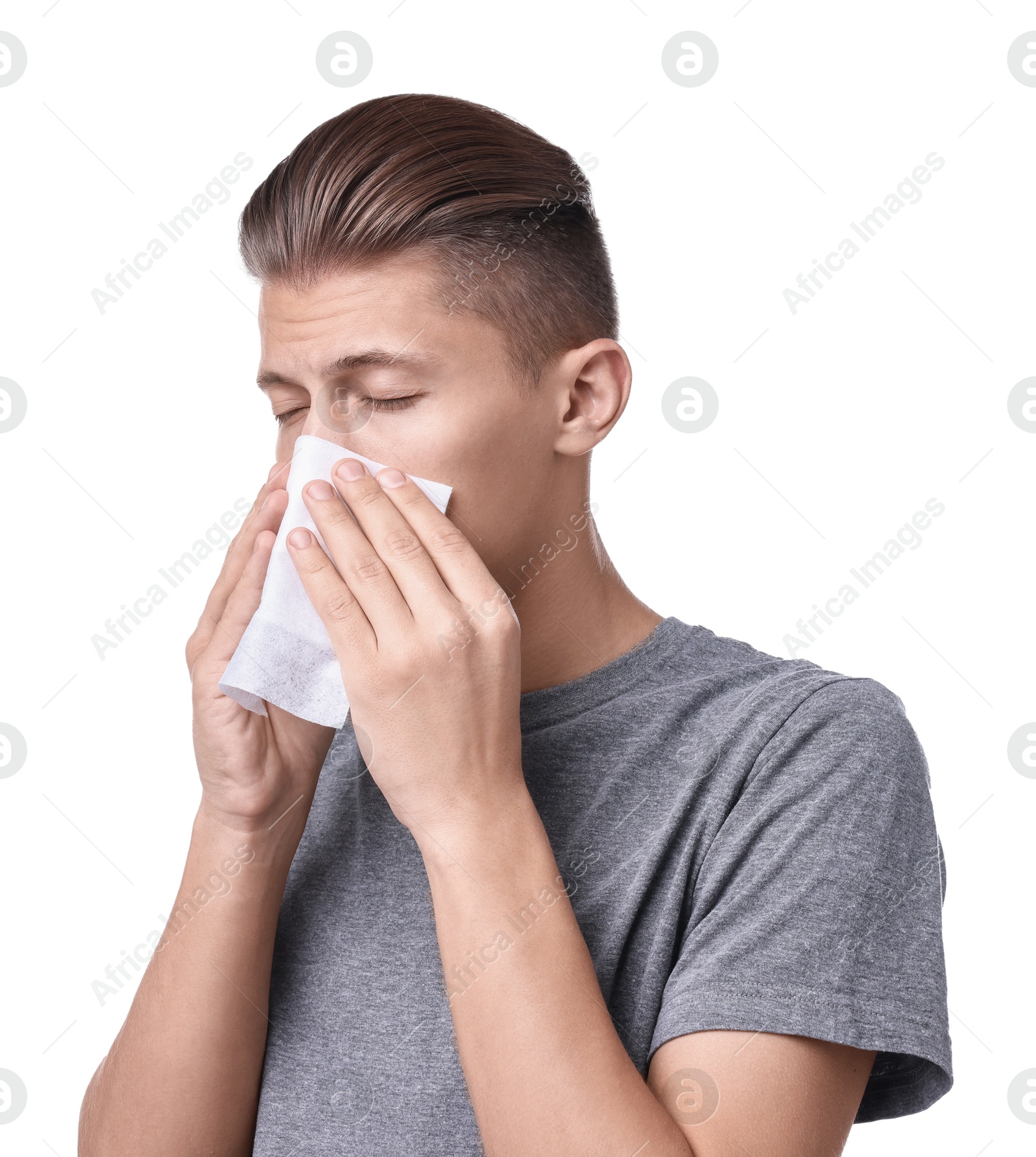 Photo of Young man with tissue suffering from sinusitis on white background